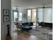 Spacious living room featuring modern furniture, ceiling fans, and sliding glass doors leading to a balcony at 130 Riviera Dunes Way # 304, Palmetto, FL 34221