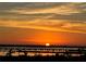 Scenic sunset view overlooking calm waters and distant structures, casting an orange glow across the sky at 130 Riviera Dunes Way # 304, Palmetto, FL 34221