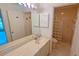 Bright bathroom featuring a tiled walk-in shower with unique glass block detail and a neutral-toned vanity at 1311 Siesta Bayside Dr # 1311-A, Sarasota, FL 34242