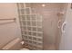 Bathroom featuring a tiled shower with grab bars and a glass block privacy wall at 1311 Siesta Bayside Dr # 1311-A, Sarasota, FL 34242