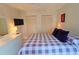 Bedroom with light walls showcasing a queen bed, large closets and decoratively framed artwork at 1311 Siesta Bayside Dr # 1311-A, Sarasota, FL 34242