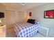 Bright bedroom features a queen bed with new gray floors and white baseboards with double closets at 1311 Siesta Bayside Dr # 1311-A, Sarasota, FL 34242