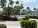 Inviting community pool area shows palm trees and seating with buildings in the background at 1311 Siesta Bayside Dr # 1311-A, Sarasota, FL 34242