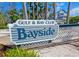 Gulf & Bay Club Bayside entrance sign with lush landscaping and coastal architecture at 1311 Siesta Bayside Dr # 1311-A, Sarasota, FL 34242