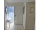 Bright entryway featuring stylish decor, a white door, and white laminate flooring at 1311 Siesta Bayside Dr # 1311-A, Sarasota, FL 34242