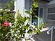 Close-up of the home's address surrounded by flourishing flora at 1311 Siesta Bayside Dr # 1311-A, Sarasota, FL 34242