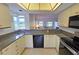Well-lit kitchen featuring sleek countertops and appliances, seamlessly connecting to the living area at 1311 Siesta Bayside Dr # 1311-A, Sarasota, FL 34242