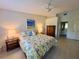 Spacious main bedroom featuring a decorative ceiling fan, lamps, and ensuite access at 1311 Siesta Bayside Dr # 1311-A, Sarasota, FL 34242