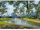 Scenic view of property overlooking a pond with fountain and surrounded by well-maintained landscaping at 1311 Siesta Bayside Dr # 1311-A, Sarasota, FL 34242