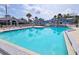 Large, inviting pool surrounded by lounge chairs and lush landscaping, perfect for relaxation at 1311 Siesta Bayside Dr # 1311-A, Sarasota, FL 34242