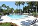 Sparkling swimming pool with lounge chairs and vibrant landscaping, perfect for relaxation at 1311 Siesta Bayside Dr # 1311-A, Sarasota, FL 34242
