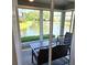 Enclosed sunroom featuring lovely water views, comfortable seating, and a calming ambiance at 1311 Siesta Bayside Dr # 1311-A, Sarasota, FL 34242