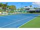 A well-maintained tennis court with a new net and vibrant blue and green surface, perfect for sports enthusiasts at 1311 Siesta Bayside Dr # 1311-A, Sarasota, FL 34242