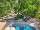 Overhead shot features the screened pool area, shed, and a beautiful landscape with mature trees at 13511 4Th Plz E, Bradenton, FL 34212