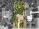 Aerial view of the property showcases a pool, lush landscaping, and neighboring homes at 13511 4Th Plz E, Bradenton, FL 34212