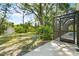 Tranquil backyard showcasing lush greenery, a shed, and a screened-in pool area at 13511 4Th Plz E, Bradenton, FL 34212
