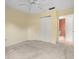 Bedroom with cream carpet, large closet, and doorway to a nearby bathroom at 13511 4Th Plz E, Bradenton, FL 34212