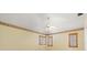 Bedroom features a fan and light, shuttered windows, and neutral carpeting at 13511 4Th Plz E, Bradenton, FL 34212
