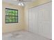 Bedroom with cream carpet, ceiling fan and a large closet at 13511 4Th Plz E, Bradenton, FL 34212