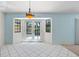 Dining room features white tiled floors, chandelier and French doors to backyard at 13511 4Th Plz E, Bradenton, FL 34212