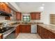 Kitchen with granite countertops, stainless steel appliances, and cherry cabinets at 13511 4Th Plz E, Bradenton, FL 34212