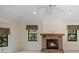 Spacious living room featuring a stone fireplace, large windows and neutral paint at 13511 4Th Plz E, Bradenton, FL 34212
