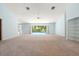 Spacious living room with neutral carpet, fan and access to lanai & pool at 13511 4Th Plz E, Bradenton, FL 34212