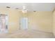 Carpeted main bedroom features a ceiling fan and doorway to the main bathroom at 13511 4Th Plz E, Bradenton, FL 34212