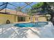 Inviting screened-in pool area with a sparkling pool and multiple access points to the house at 13511 4Th Plz E, Bradenton, FL 34212