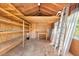 Interior view of a well-organized shed, featuring ample shelving, a workbench, and a ladder at 13511 4Th Plz E, Bradenton, FL 34212
