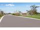Palm Wind entrance showcases attractive landscaping, palm trees, and an elegant stone-and-wood community sign at 13634 Tropical Breeze Way, Hudson, FL 34669