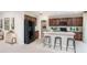 A modern kitchen with stainless steel appliances, a pantry, and an island with countertop seating at 13634 Tropical Breeze Way, Hudson, FL 34669