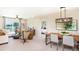 Open-concept living and dining area, featuring bright natural light, modern decor, and comfortable seating at 13634 Tropical Breeze Way, Hudson, FL 34669