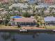 Waterfront home featuring a screened lanai, dock, and easy access to water activities at 1450 Aqui Esta Dr, Punta Gorda, FL 33950