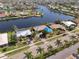 A waterfront home on a canal with mature palm trees, great curb appeal, and access to the bay at 1450 Aqui Esta Dr, Punta Gorda, FL 33950