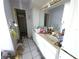 Untidy bathroom showcasing a sink, large mirror, white cabinets, and a shower stall at 1450 Aqui Esta Dr, Punta Gorda, FL 33950