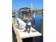 Resident on dock showing off a large fish with boat and calm canal in the background at 1450 Aqui Esta Dr, Punta Gorda, FL 33950