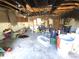 Damaged garage features various items strewn around and exposed roof and ceiling at 1450 Aqui Esta Dr, Punta Gorda, FL 33950