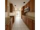 Galley kitchen features granite countertops and ample cabinet space at 1450 Aqui Esta Dr, Punta Gorda, FL 33950