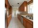 Galley kitchen with stainless steel appliances, granite countertops, and tiled backsplash at 1450 Aqui Esta Dr, Punta Gorda, FL 33950
