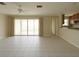 Spacious living room with sliding doors and tile flooring, seamlessly connecting indoor and outdoor spaces at 1450 Aqui Esta Dr, Punta Gorda, FL 33950