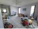 Cluttered living room with tile flooring, multiple windows and a ceiling fan at 1450 Aqui Esta Dr, Punta Gorda, FL 33950