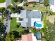 Stunning aerial view of a home featuring a kidney-shaped pool, manicured lawn, and a spacious driveway at 1660 Pine Harrier Cir, Sarasota, FL 34231