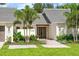 Welcoming entryway with modern double doors, lush landscaping, and elegant exterior lighting fixtures at 1660 Pine Harrier Cir, Sarasota, FL 34231
