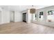 Spacious living room with hardwood floors, recessed lighting, front door, and natural light from three windows at 1660 Pine Harrier Cir, Sarasota, FL 34231