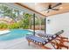 Inviting pool area with sun loungers and tropical landscaping, perfect for relaxation and outdoor entertaining at 1660 Pine Harrier Cir, Sarasota, FL 34231