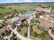 Overhead view showcasing the community's resort-style pool and clubhouse, surrounded by palm trees and manicured grounds at 16904 Vardon Ter # 201, Bradenton, FL 34211