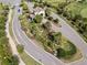 Aerial view of the landscaped entrance with ponds, palm trees, and manicured greenery at 16904 Vardon Ter # 201, Bradenton, FL 34211