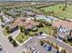 Expansive aerial view highlighting the community's clubhouse, tennis courts, pool, and lush landscaping at 16904 Vardon Ter # 201, Bradenton, FL 34211