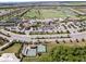 Breathtaking aerial view of a community offering amazing tennis and pool amenities with mature tropical landscaping at 16904 Vardon Ter # 201, Bradenton, FL 34211